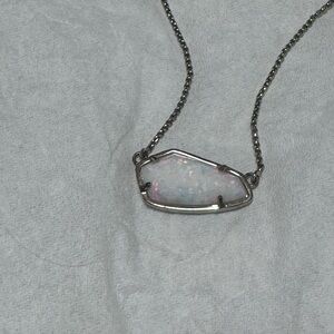 White Kendra Scott necklace. Gold chain.